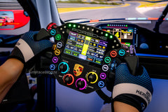 GRID Porsche 911 RSR steering wheel illuminated in an installed sim racing cockpit